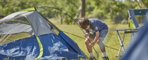 Scout setting up a tent
