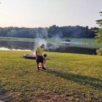 volunteers by camp fire photo