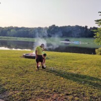 volunteers by camp fire photo