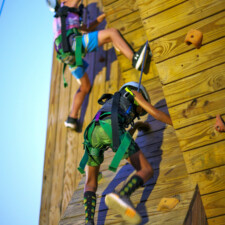 Climbing scouts on climbing tower photo
